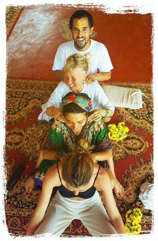 yoga students give a massage in a group