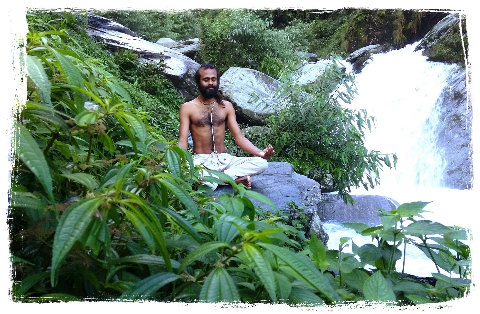 yoga teacher is meditating at the waterfall