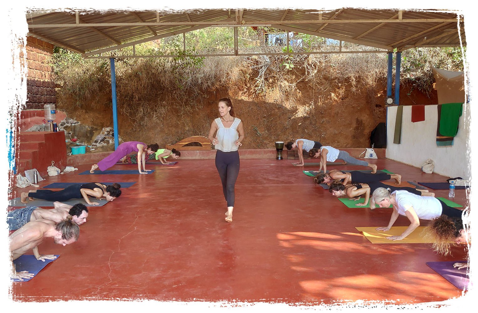 female yoga teacher is teaching a vinyasayoga class