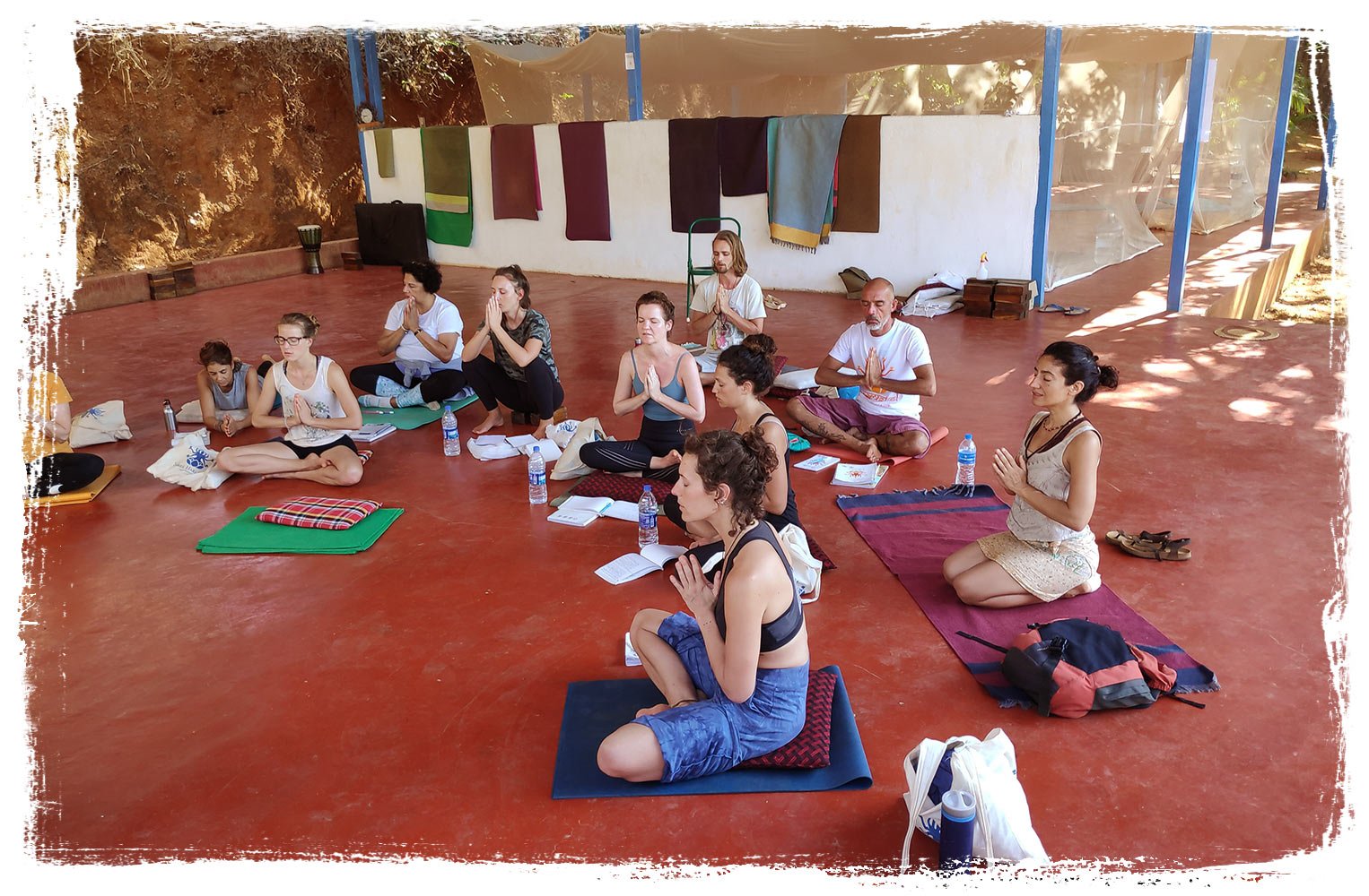 yoga students in lotus pose, praying